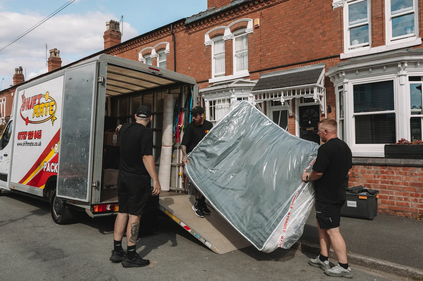 ShiftMate Removals Birmingham team loading protected furniture into a van