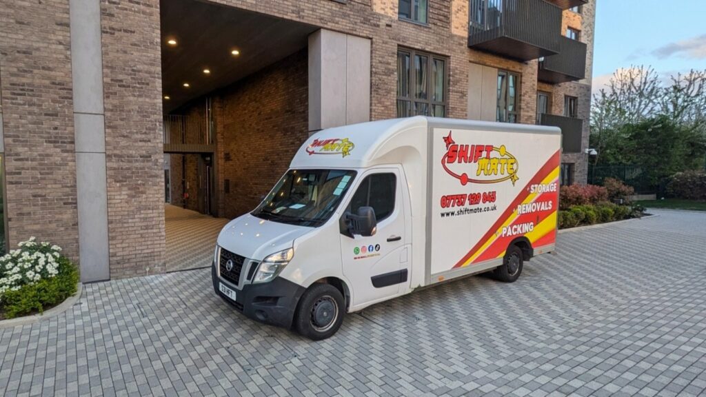 house removals UK van outside modern apartment building