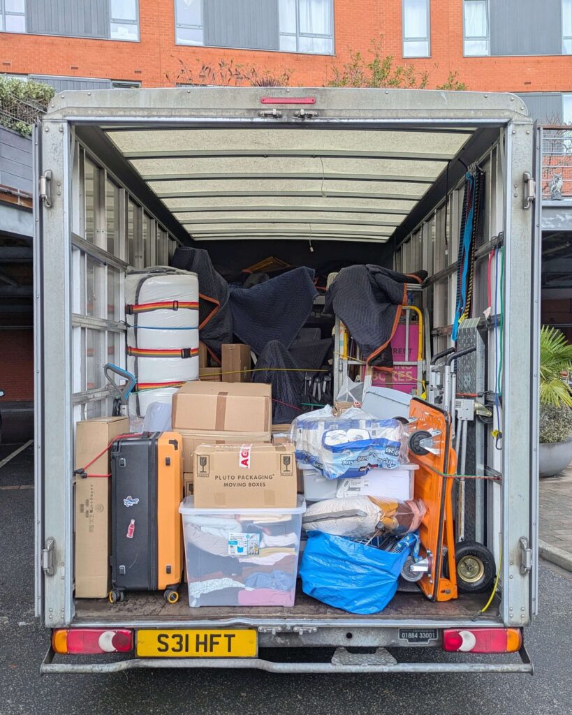 Furniture and boxes securely packed inside removal van during house move in West Bromwich