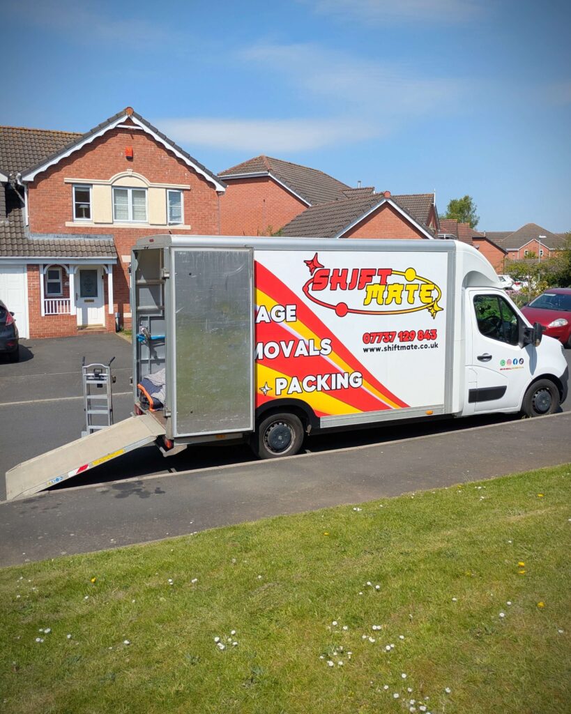 House removals UK team loading a van using a ramp during a professional home move