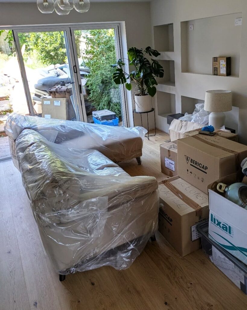 Protected furniture and packed boxes prepared for a house move in Birmingham