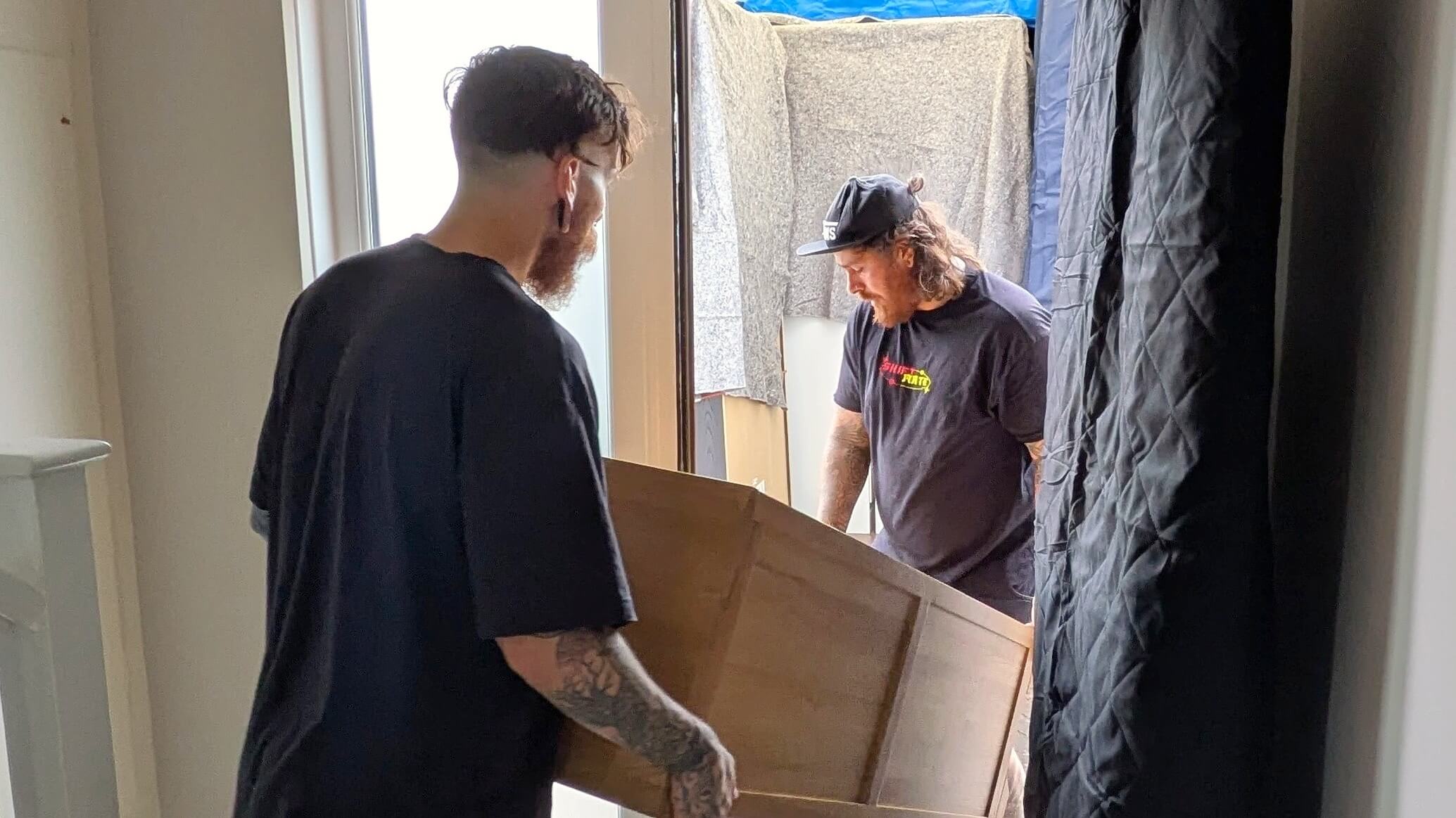 Man and van team carrying furniture into a property