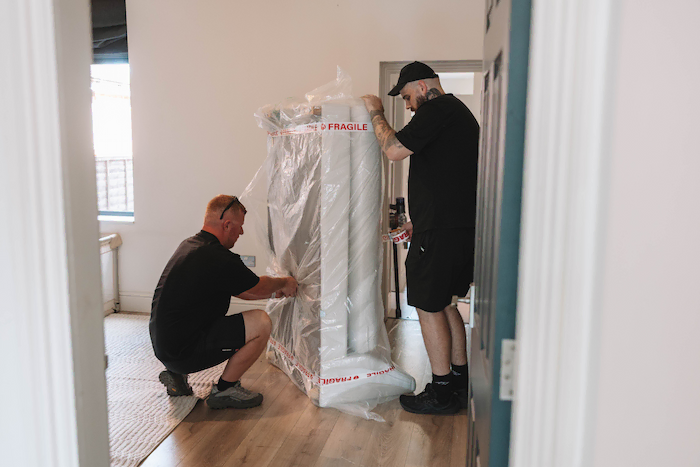 Two ShiftMate packers covering a furniture for protection