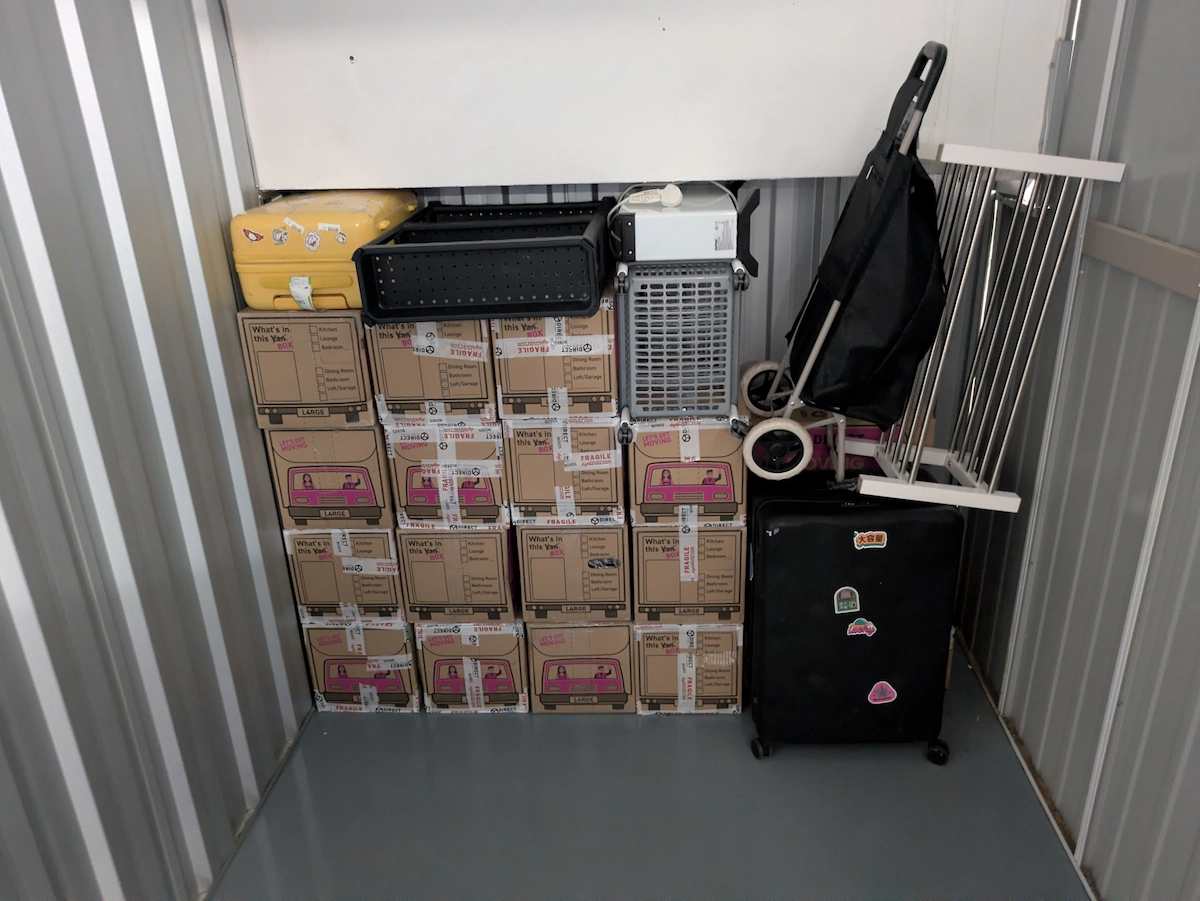 Customer boxes and household belongings arranged inside a storage unit by ShiftMate Removals
