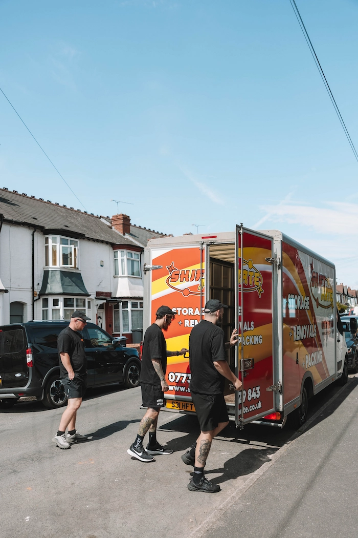 ShiftMate removal team working beside a branded van on a residential street